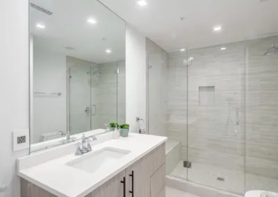 A modern bathroom with a glass shower stall.