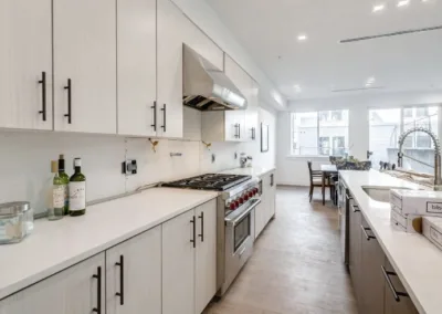 A kitchen with white cabinets and stainless steel appliances.